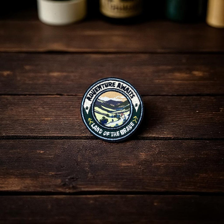 Big Country Adventure Awaits Round Patch on rustic wood bench