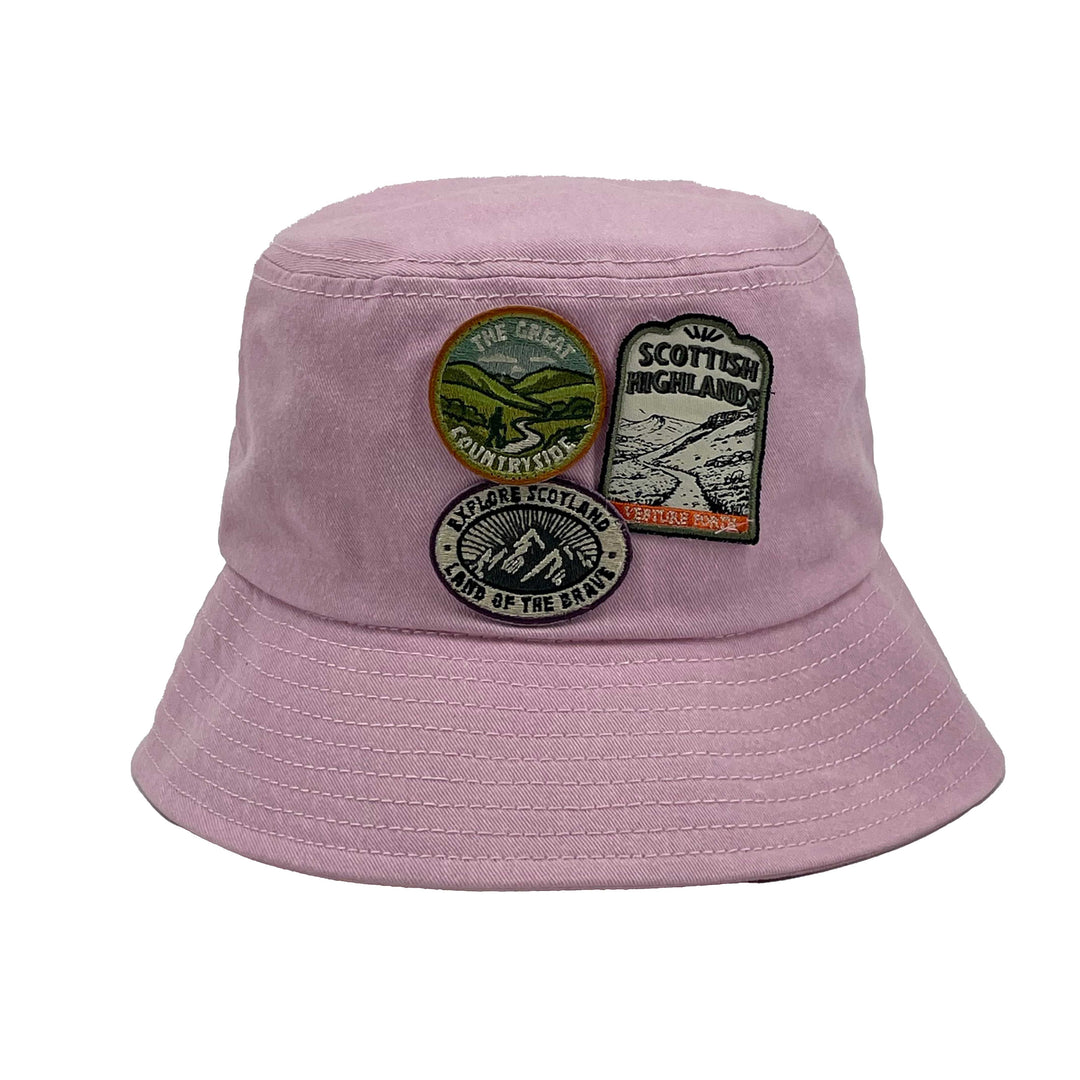 Pink bucket hat with patches on a white background