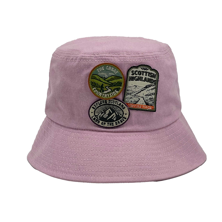 Pink bucket hat with patches on a white background