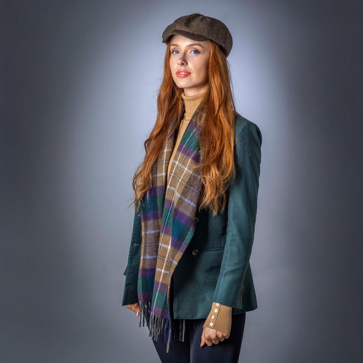 Man wearing a pure wool tartan scarf over a dark roll-neck jumper
