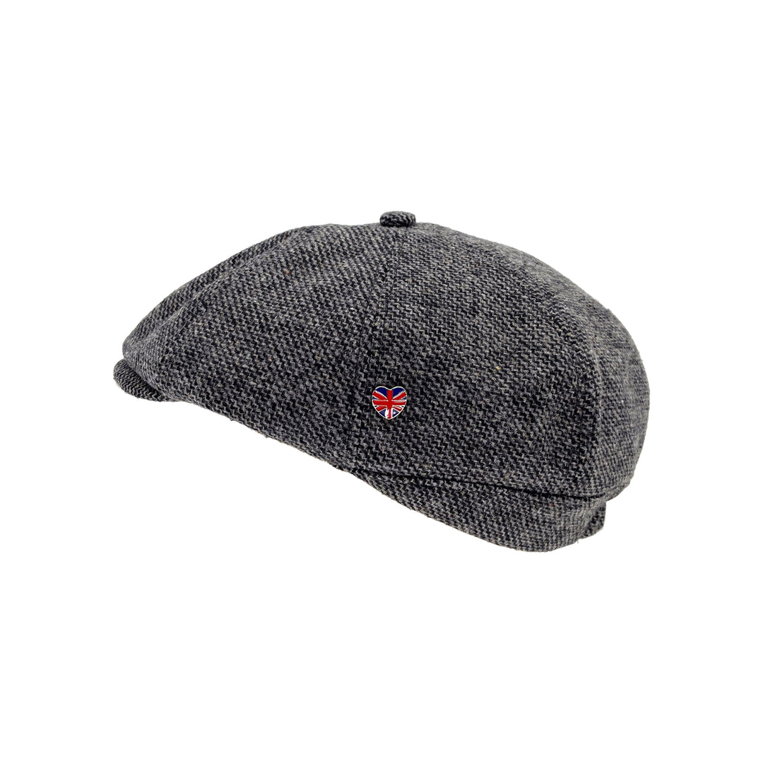 Gray flat cap with a small red heart and British flag emblem on a white background