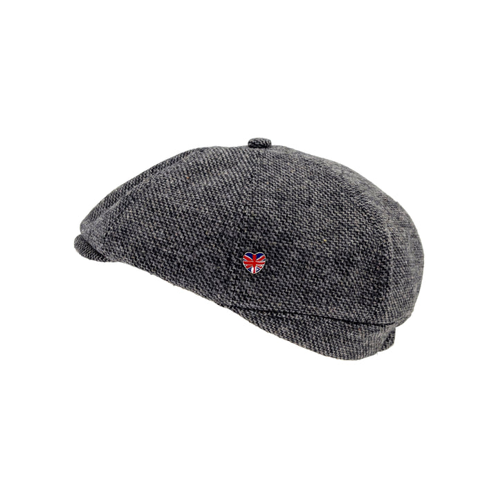 Gray flat cap with a small red heart and British flag emblem on a white background