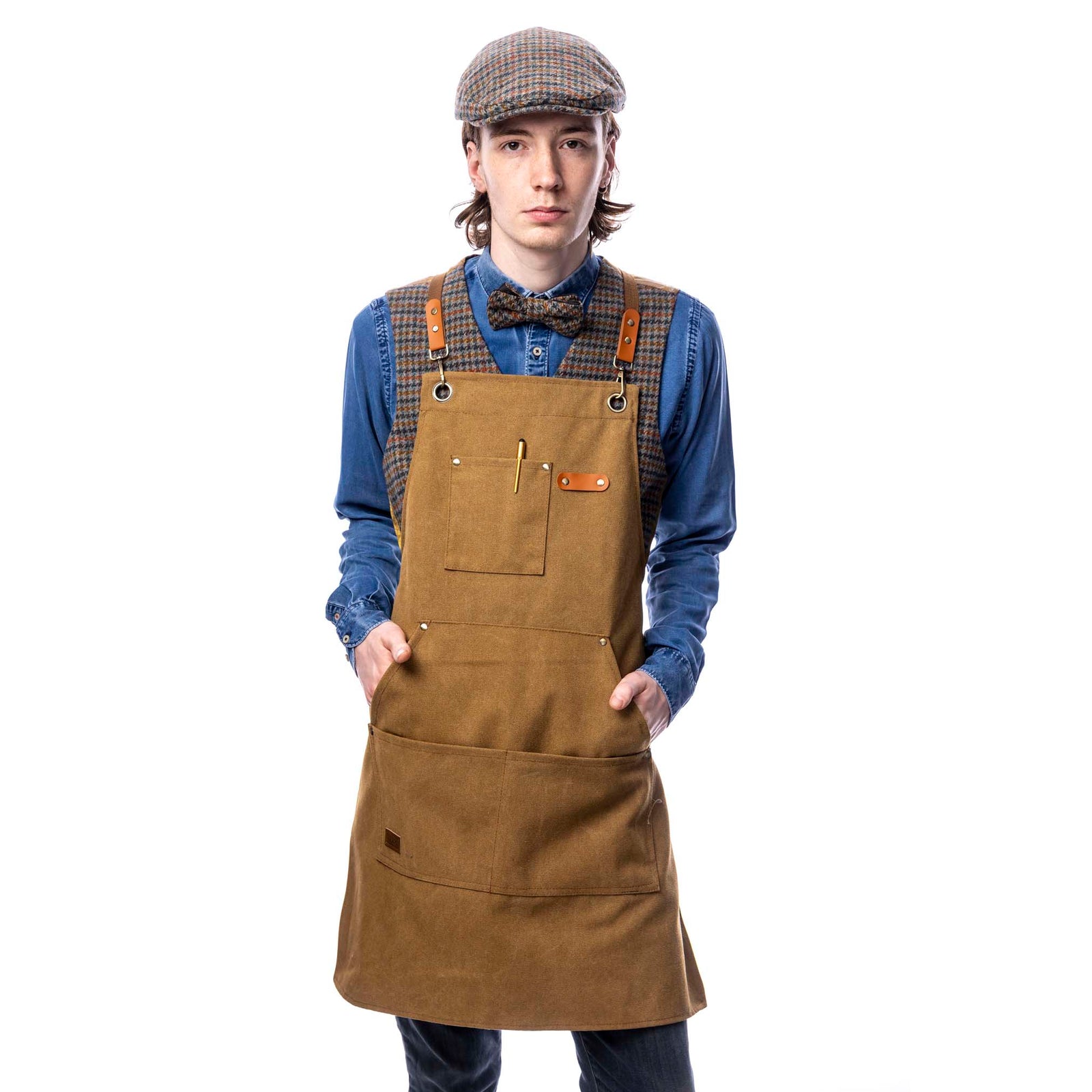 Male wearing a tan apron and flat cap standing against a white background.